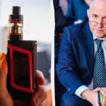 Електронна сигарета у руці на нейтральному фоні